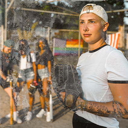 person holding a baseball bit outside with friends