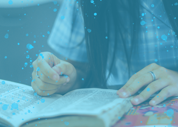 A girl with long black hair reading a book