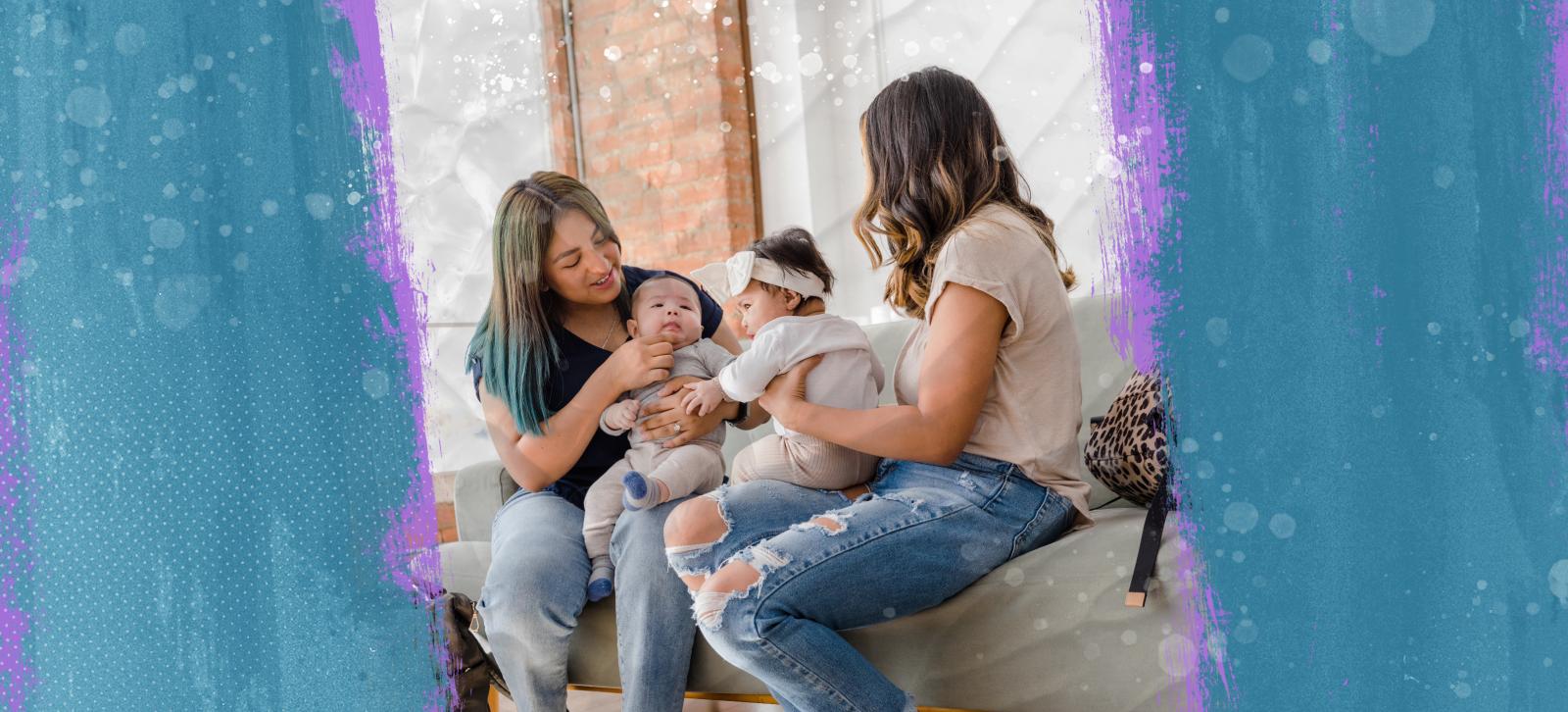 Two moms holding their babies in their laps and sitting next to each other.