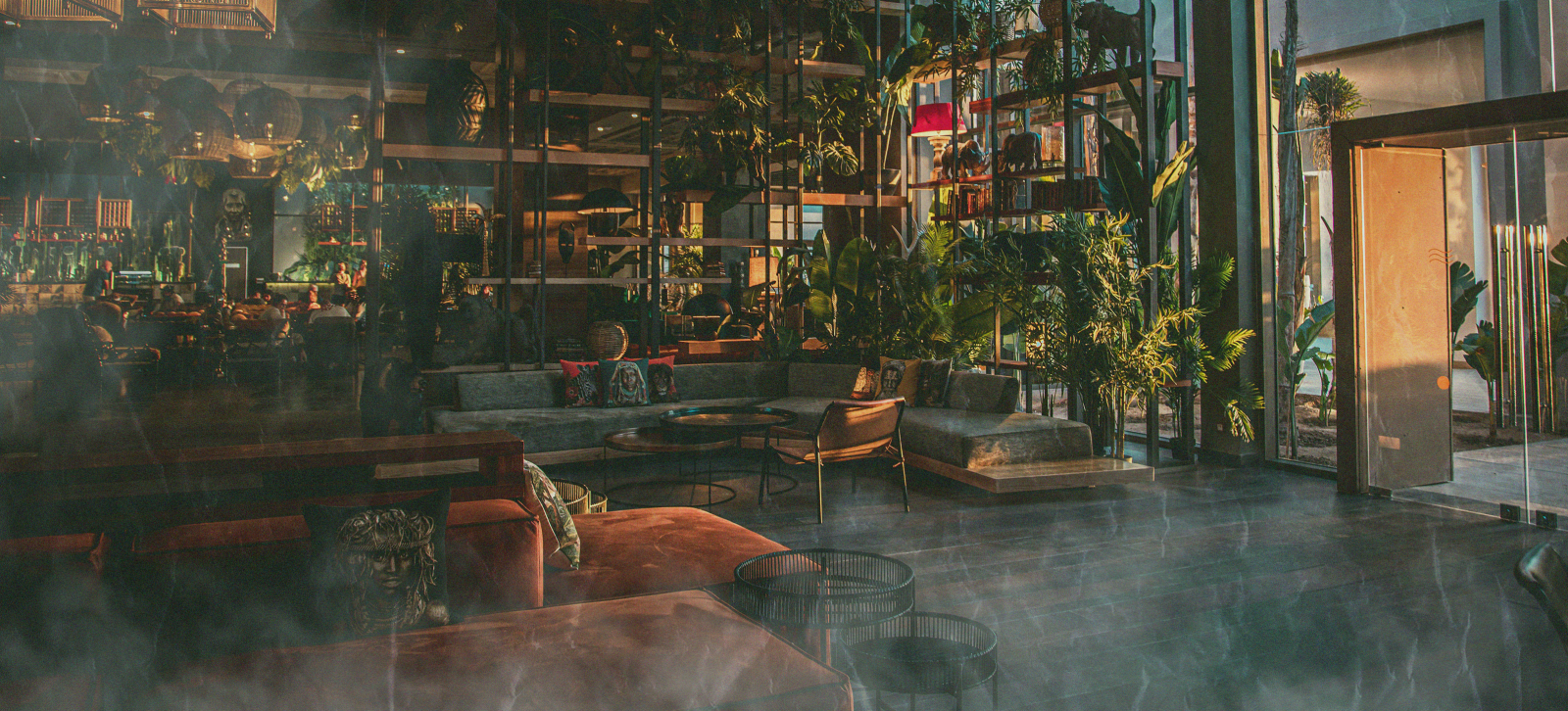 A lounge with couches covered in a cloud of smoke.