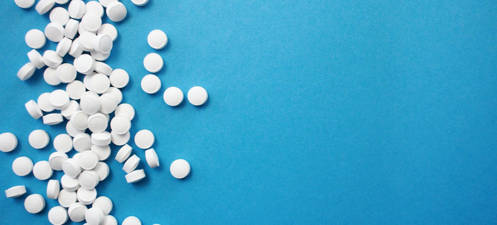 White pills on a blue background