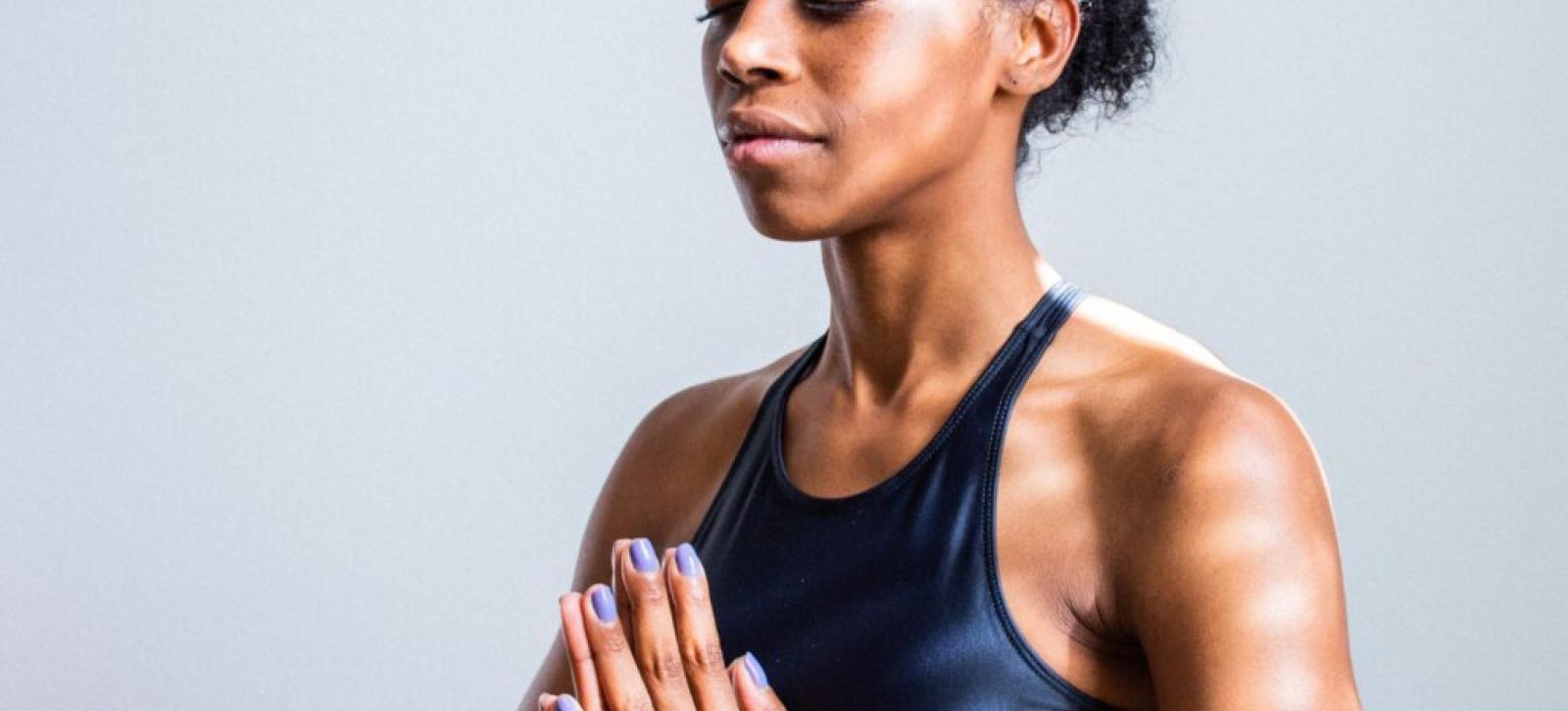 Person meditating with closed eyes.